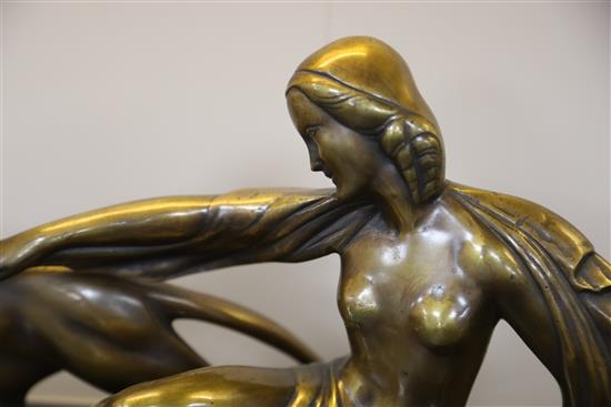 Michel Decoux (1837-1924). An Art Deco bronze group of a reclining woman with two panthers, 22.75in.